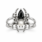 A silver spider ring featuring a faceted black teardrop gemstone, a round white pearl, and textured silver bead-like spider legs, set against a plain white background.