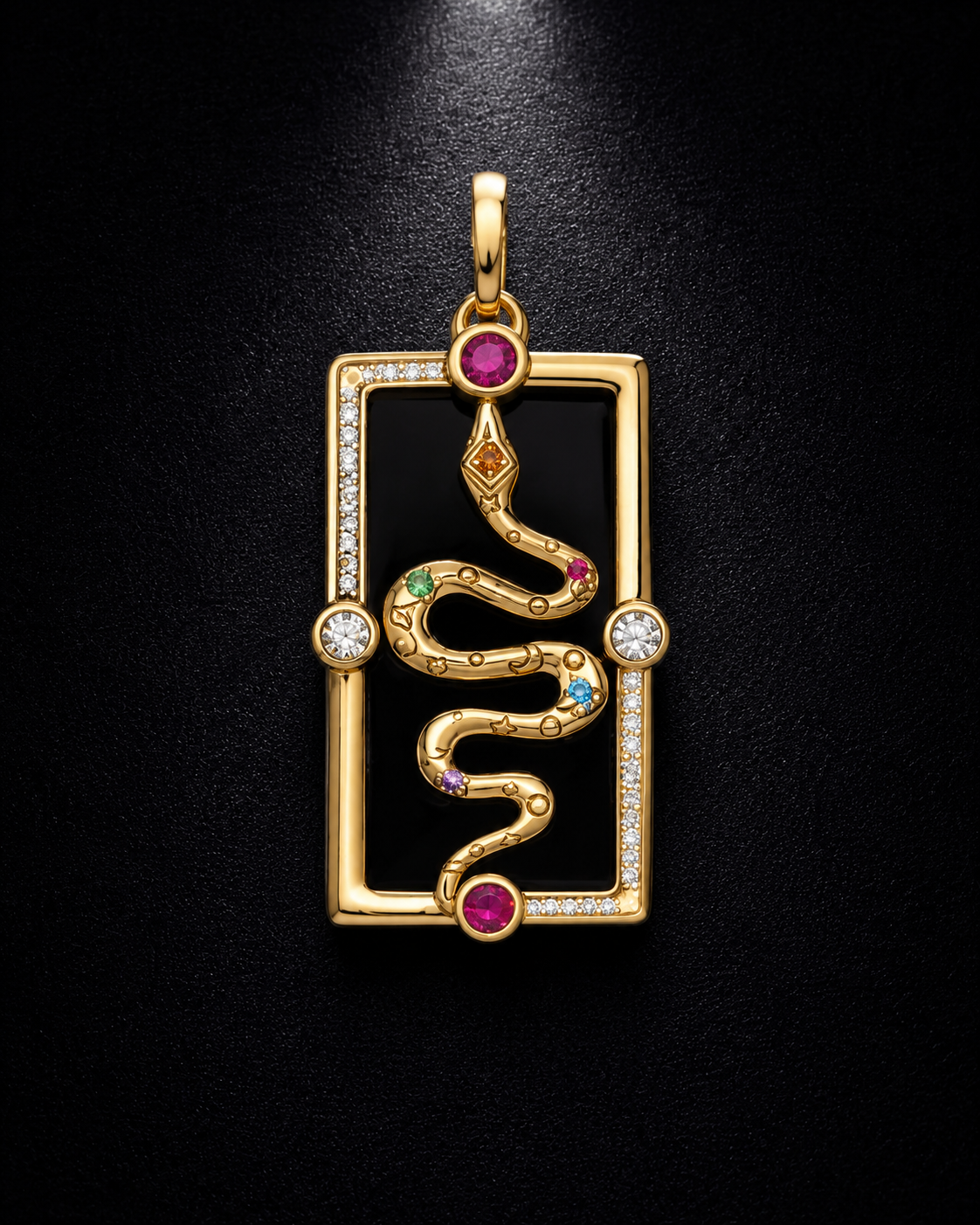 A luxury gold pendant featuring a stylized snake coiled inside a rectangular border, embellished with diamonds, pink gemstones, and small green and blue accent stones on a black background.