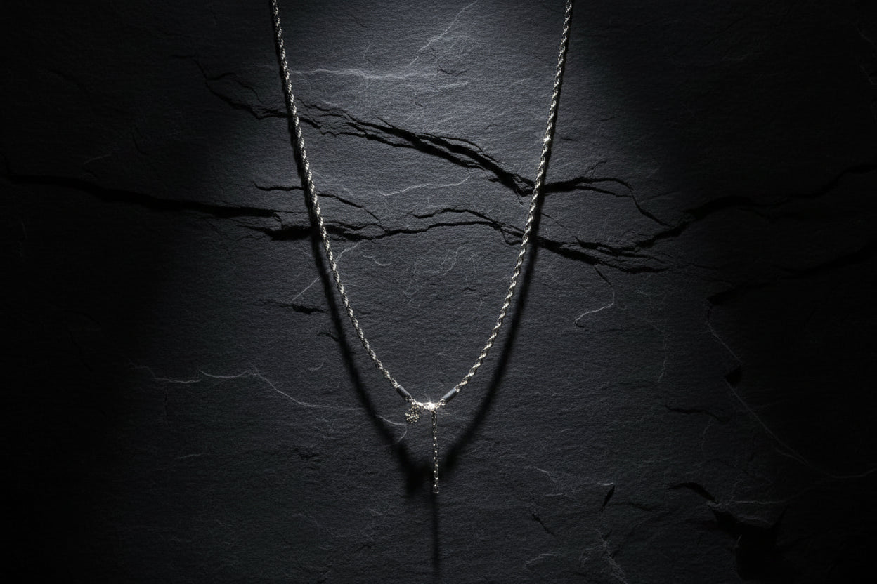 Silver necklace on a white mannequin bust with a blurred indoor background
