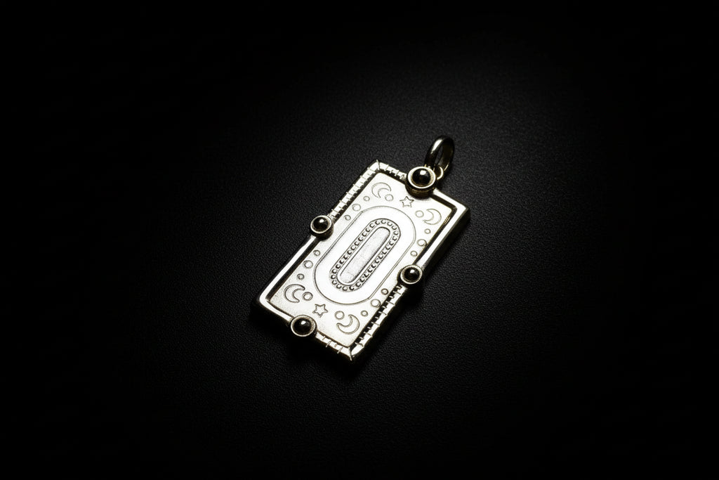 Gold pendant with decorative design on ablakc n white background